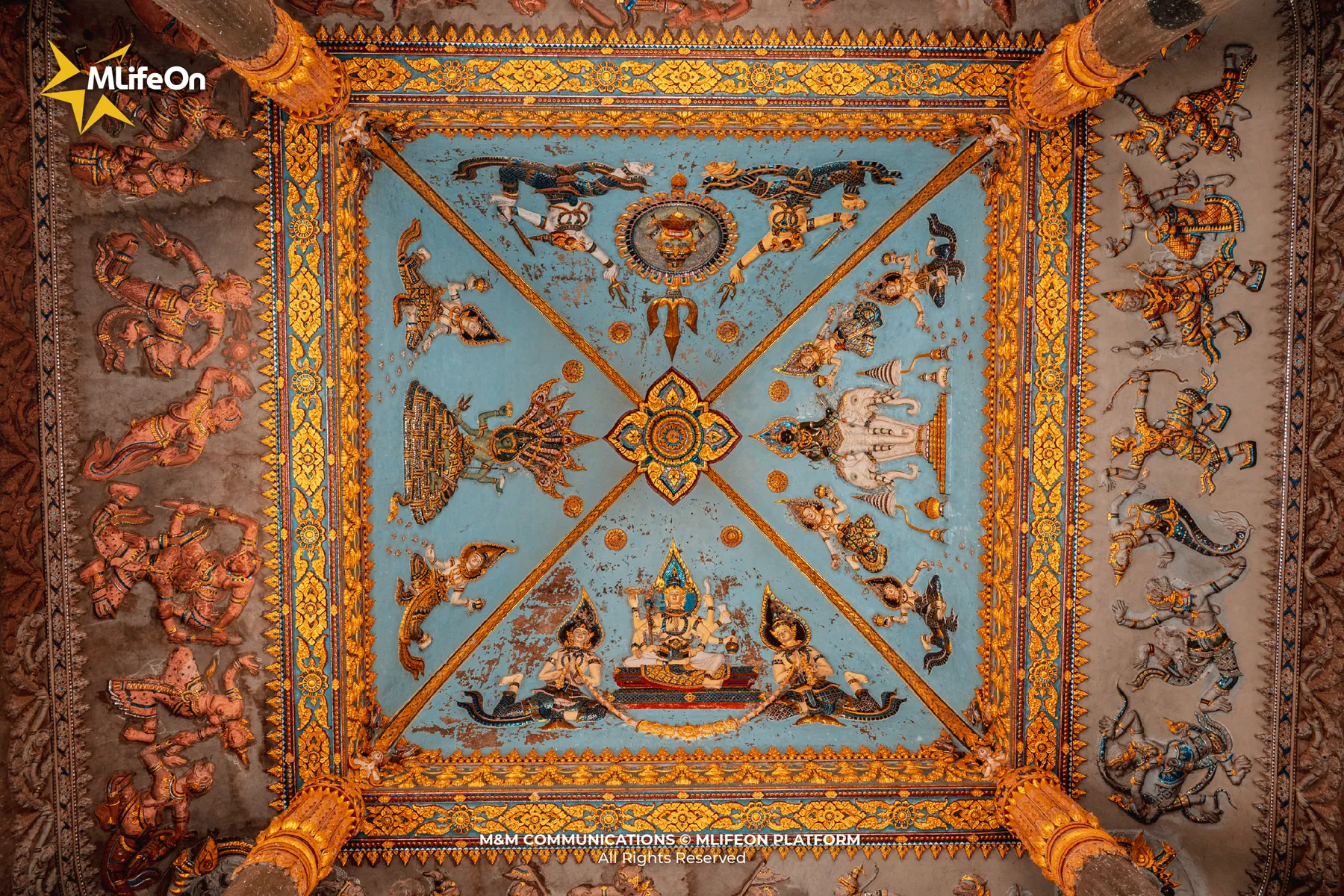 The vaulted ceiling is painted in warm golden tones, depicting the celestial realm in Buddhist cosmology.